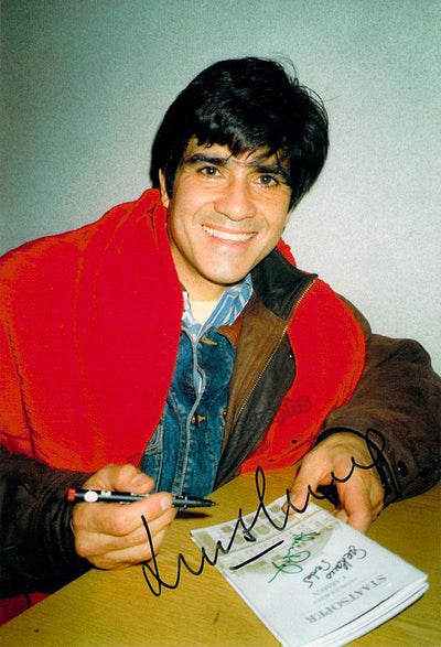 As himself signing autographs